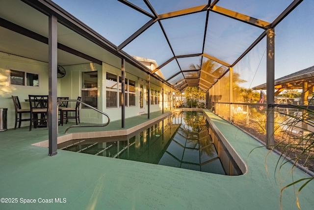 view of swimming pool with glass enclosure