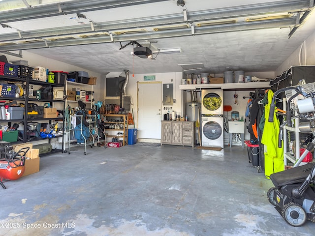 garage with a garage door opener, electric panel, a workshop area, and gas water heater