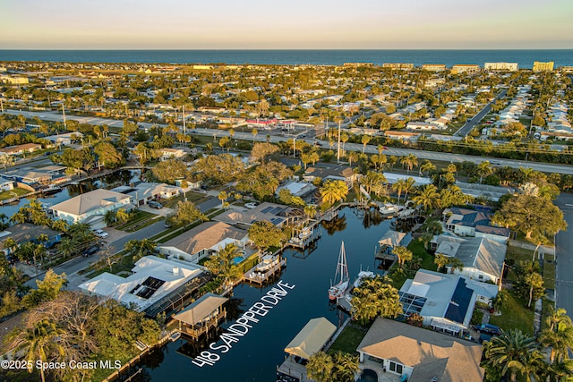 aerial view at dusk with a water view