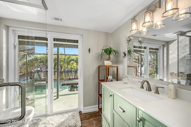 bathroom with wood-type flooring, vanity, and a wealth of natural light