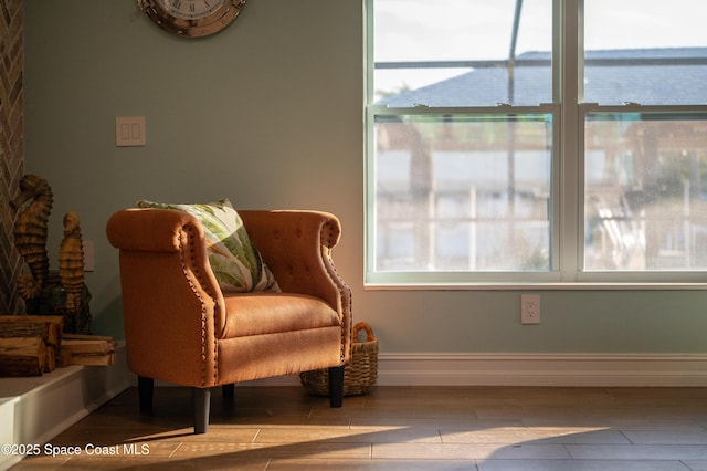 sitting room featuring a water view and light hardwood / wood-style flooring