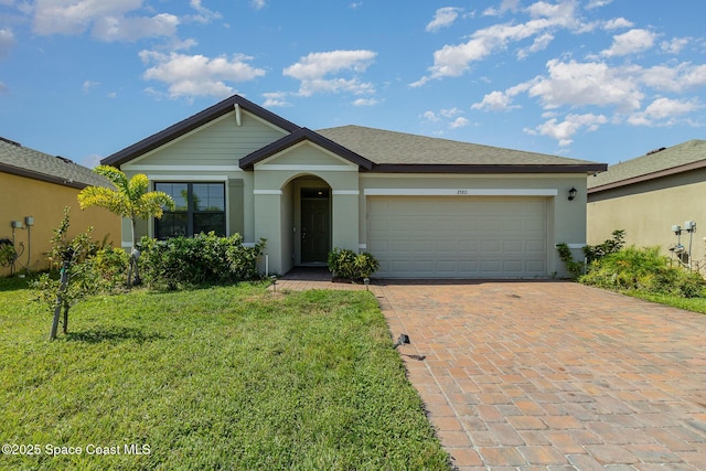 ranch-style home with a garage and a front lawn