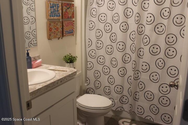 bathroom with toilet, vanity, and a shower with shower curtain