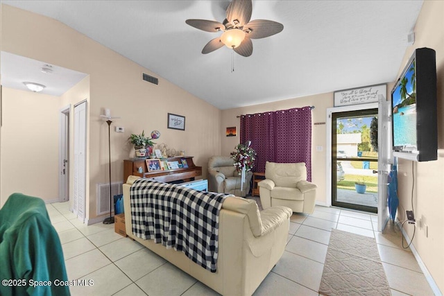 tiled living room with ceiling fan and vaulted ceiling