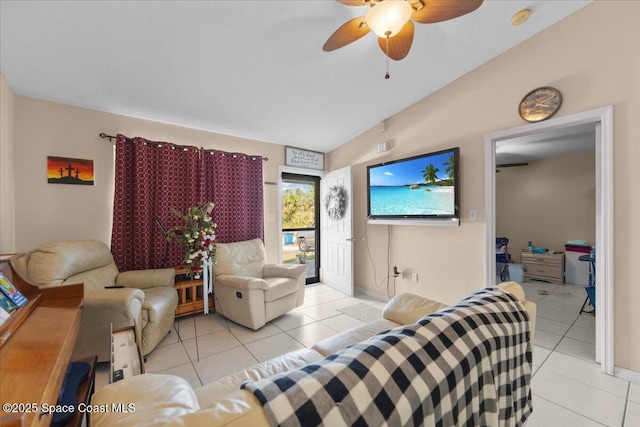 living room featuring ceiling fan, light tile patterned floors, and lofted ceiling