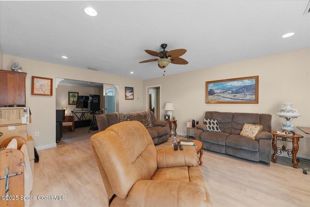 living room with ceiling fan and light hardwood / wood-style floors