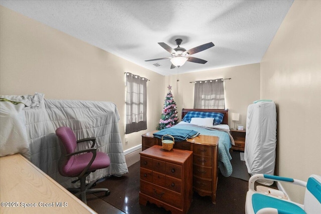 bedroom featuring ceiling fan and a textured ceiling