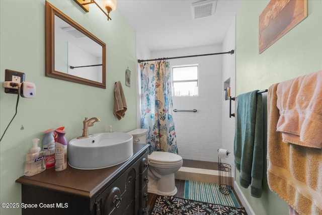 bathroom with toilet, vanity, a shower with curtain, and tile patterned floors