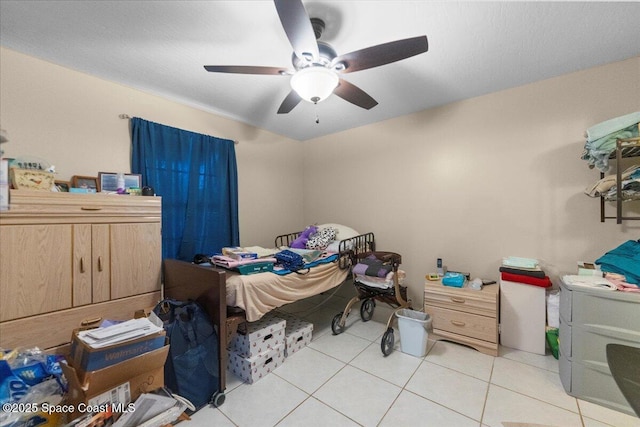 bedroom with ceiling fan and light tile patterned flooring