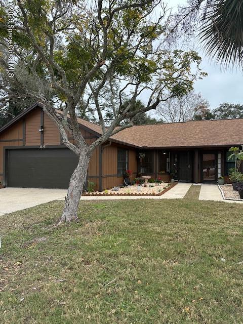 view of front of home featuring a garage and a front lawn