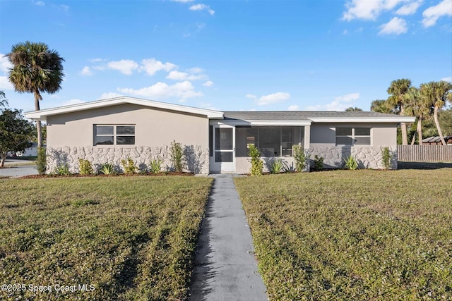 ranch-style home with a front lawn and a sunroom