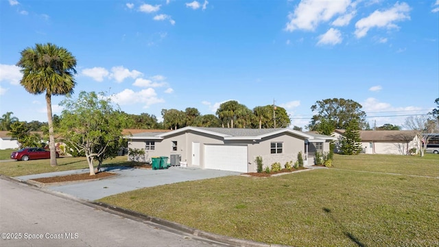 view of front of home with a front lawn, a garage, and central AC