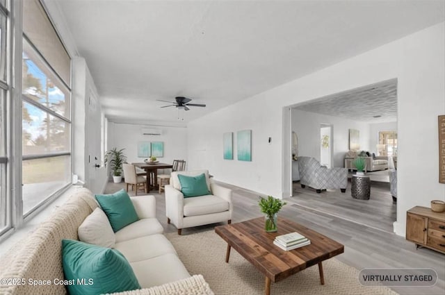 living room featuring ceiling fan and light hardwood / wood-style floors