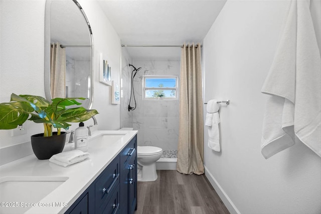 bathroom featuring toilet, vanity, a shower with shower curtain, and hardwood / wood-style flooring