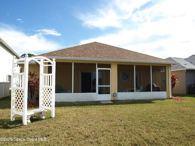 back of house with a yard and a sunroom