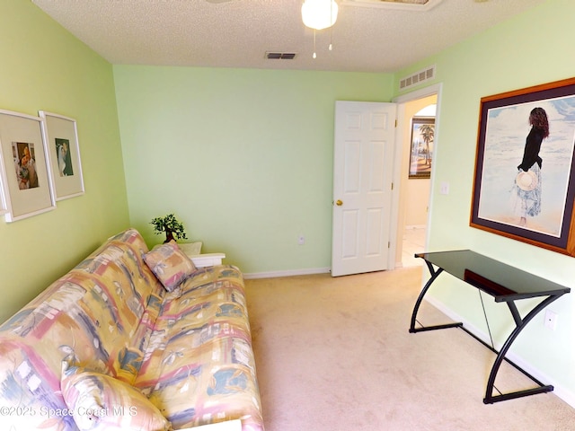 living room featuring light carpet and a textured ceiling