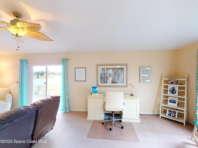 carpeted office featuring ceiling fan