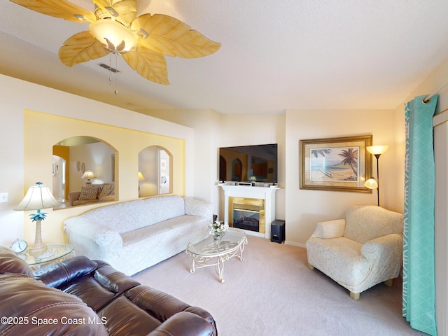 carpeted living room with vaulted ceiling and ceiling fan