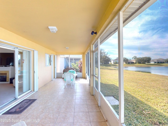 unfurnished sunroom featuring a water view and plenty of natural light