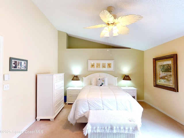 bedroom with ceiling fan, lofted ceiling, and light carpet