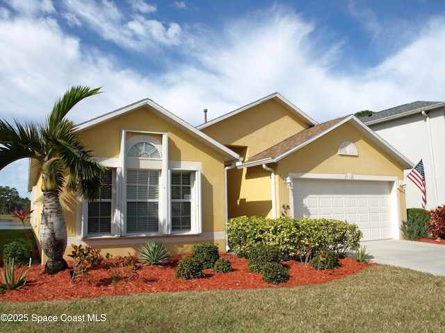 view of front of house with a garage and a front yard