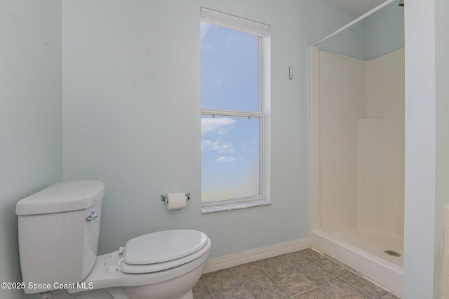 bathroom with toilet and walk in shower