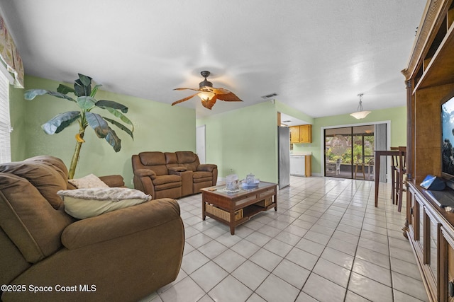 living room featuring ceiling fan and light tile patterned floors