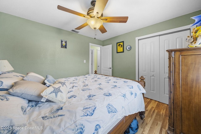 bedroom with ceiling fan, a closet, and light wood-type flooring