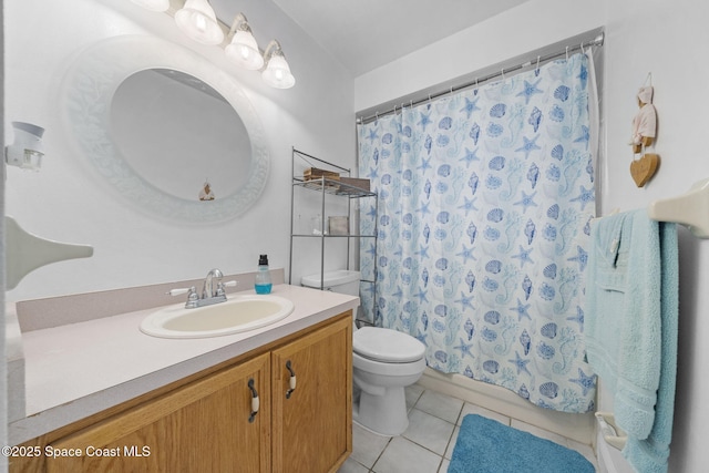 bathroom with toilet, vanity, and tile patterned flooring