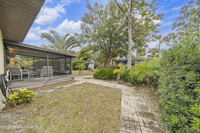 view of yard featuring a sunroom