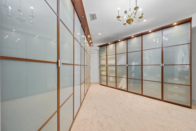 interior space with light colored carpet and an inviting chandelier