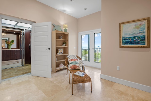 sitting room with light tile patterned floors and french doors