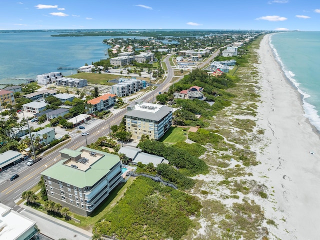 aerial view with a water view and a beach view