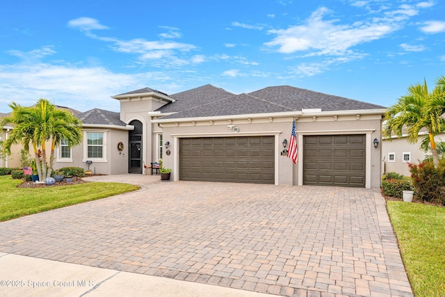 view of front facade featuring a garage and a front lawn