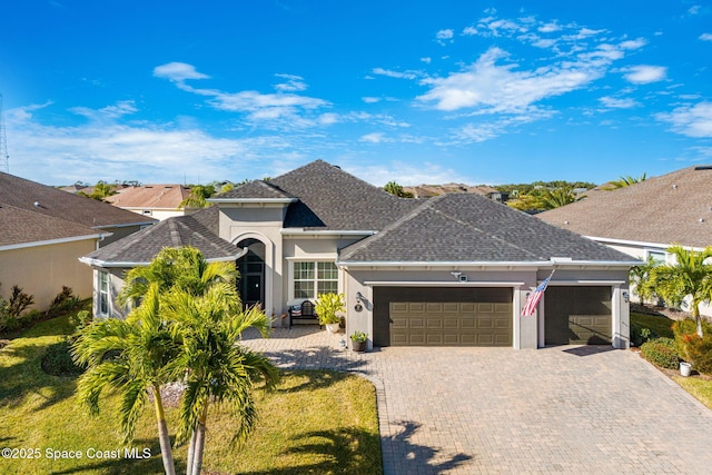 ranch-style house featuring a garage and a front lawn