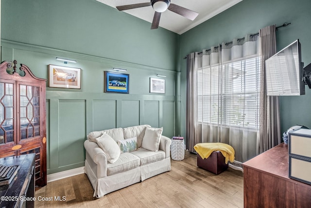 sitting room featuring light hardwood / wood-style floors and ceiling fan