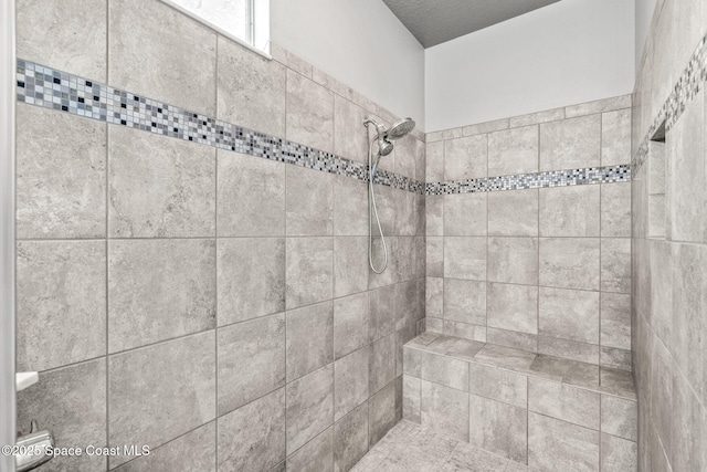 bathroom with a tile shower