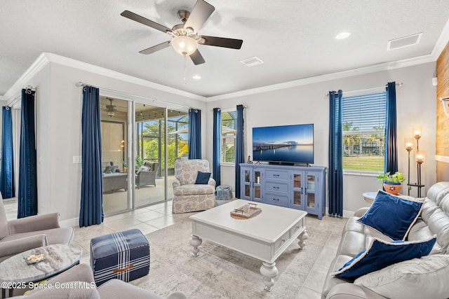 living room with light tile patterned flooring, a healthy amount of sunlight, and crown molding