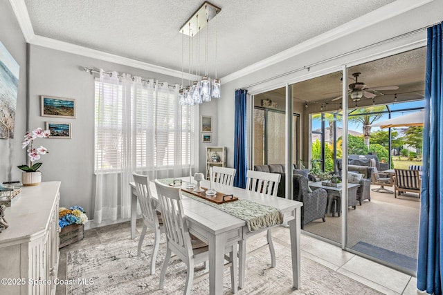 dining space with light tile patterned flooring, plenty of natural light, ceiling fan, and a textured ceiling