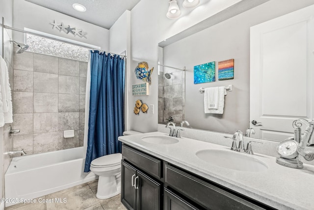 full bathroom with shower / bath combo, vanity, a textured ceiling, tile patterned floors, and toilet