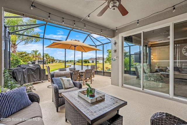 view of patio with ceiling fan, outdoor lounge area, grilling area, and glass enclosure