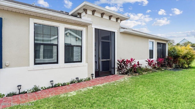 entrance to property with a yard