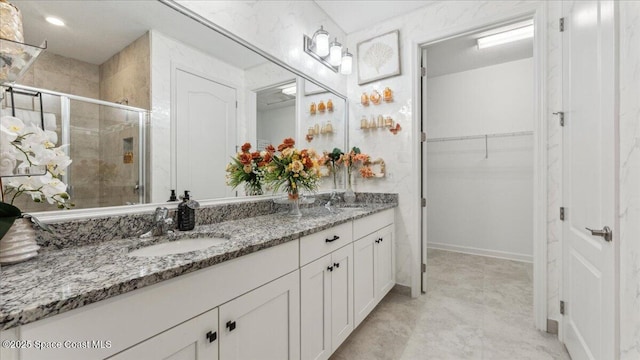 bathroom featuring an enclosed shower and vanity