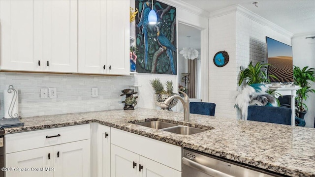 kitchen featuring dishwasher, white cabinets, light stone counters, and sink