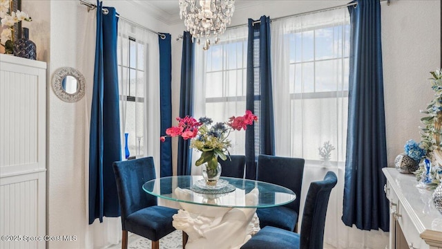 dining space with a chandelier and crown molding