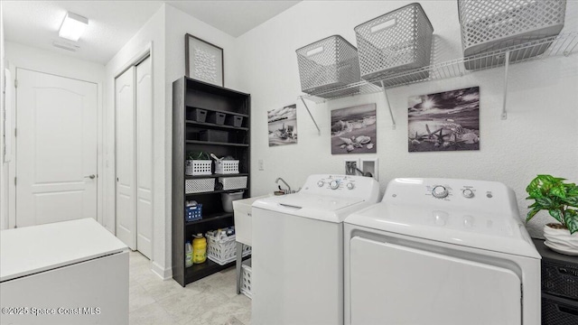 washroom featuring washer and dryer and sink