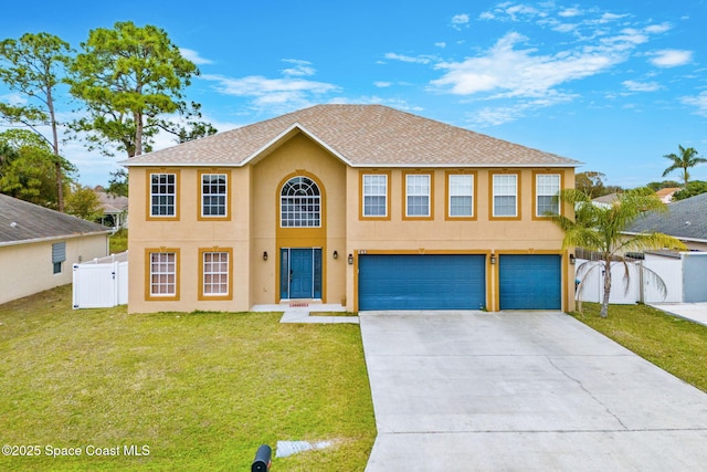 colonial home featuring a garage and a front lawn