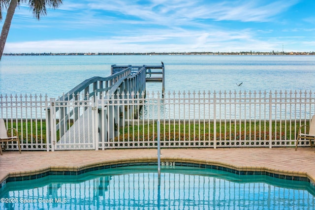 view of swimming pool featuring a water view