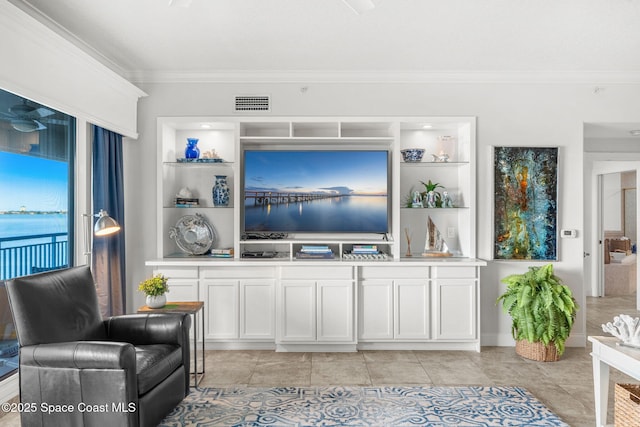 living room featuring crown molding, a water view, built in features, and light tile patterned floors