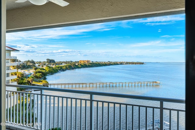 balcony with a water view and ceiling fan